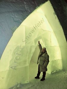 Sarah standing at the entrance to the Arctic SnowHotel in Rovaniemi, Finland
