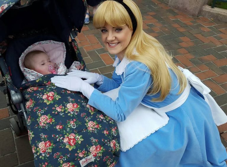 Alice in wonderland at Disneyland Paris with a baby in a pushchair asleep