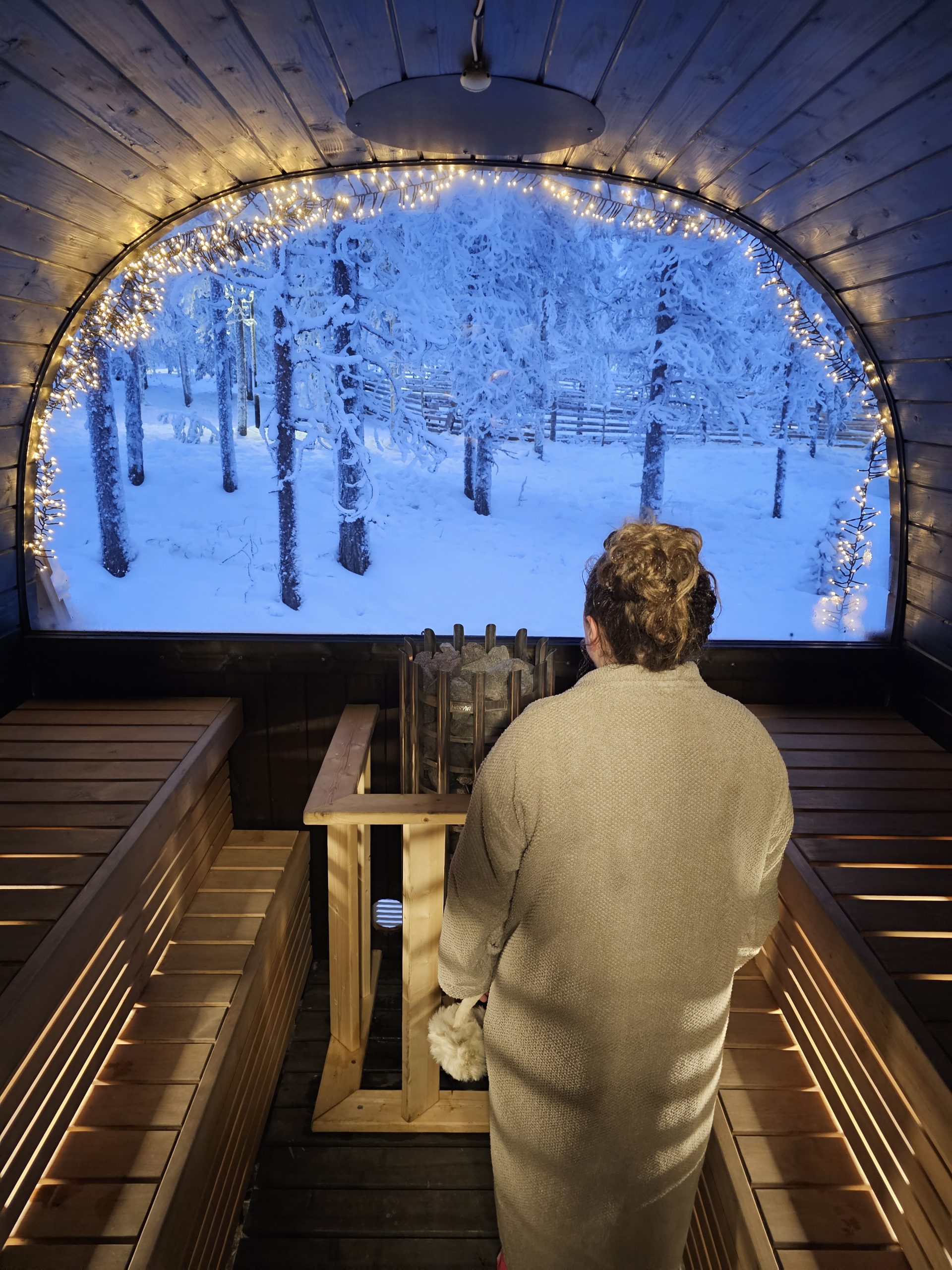 Outdoor hot tubs and saunas at Lapland Winter Park Sauna World in Rovaniemi, Finland during winter.
