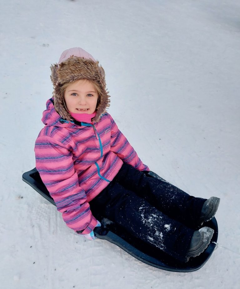 Child enjoying a Lapland holiday with Father Christmas and winter activities, showing the best age to visit Lapland with children
