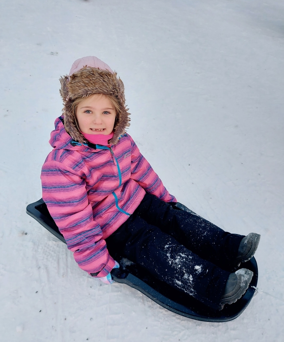 Child enjoying a Lapland holiday with Father Christmas and winter activities, showing the best age to visit Lapland with children