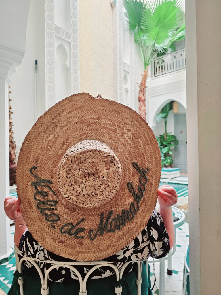 Lady wearing a hat in a riad in Marrakech